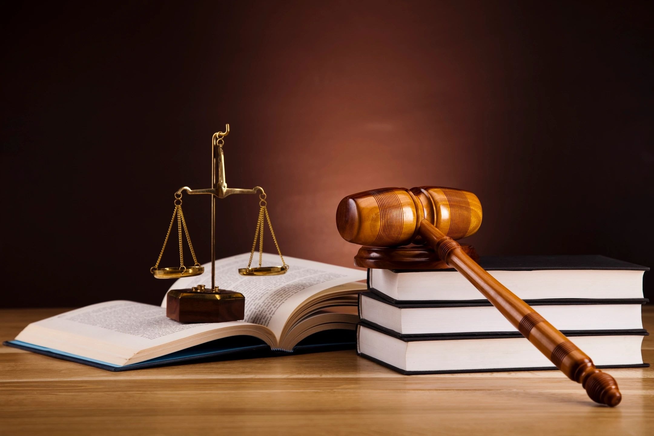 Wooden gavel and scales of justice on law books
