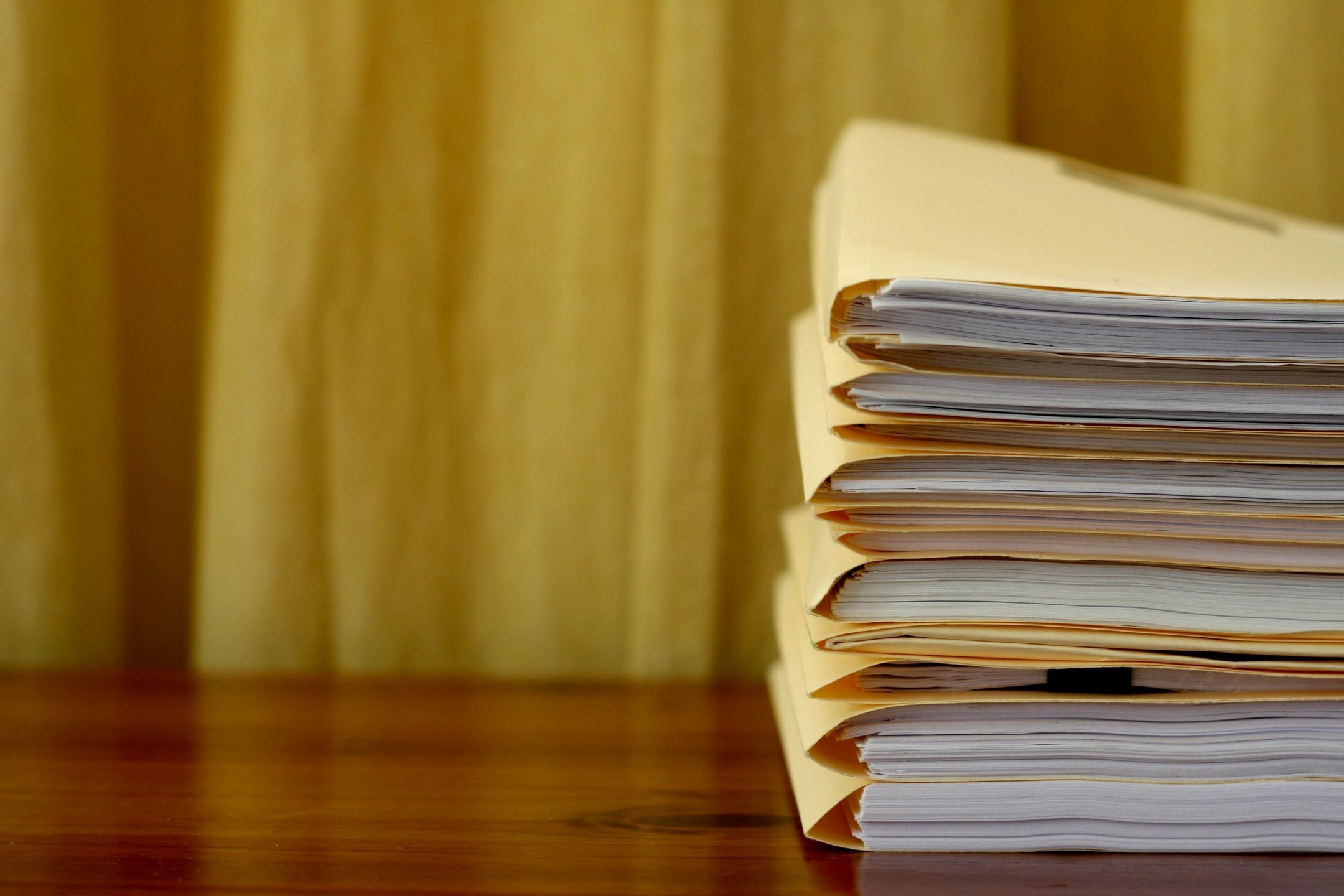 Stack of open books on wooden surface